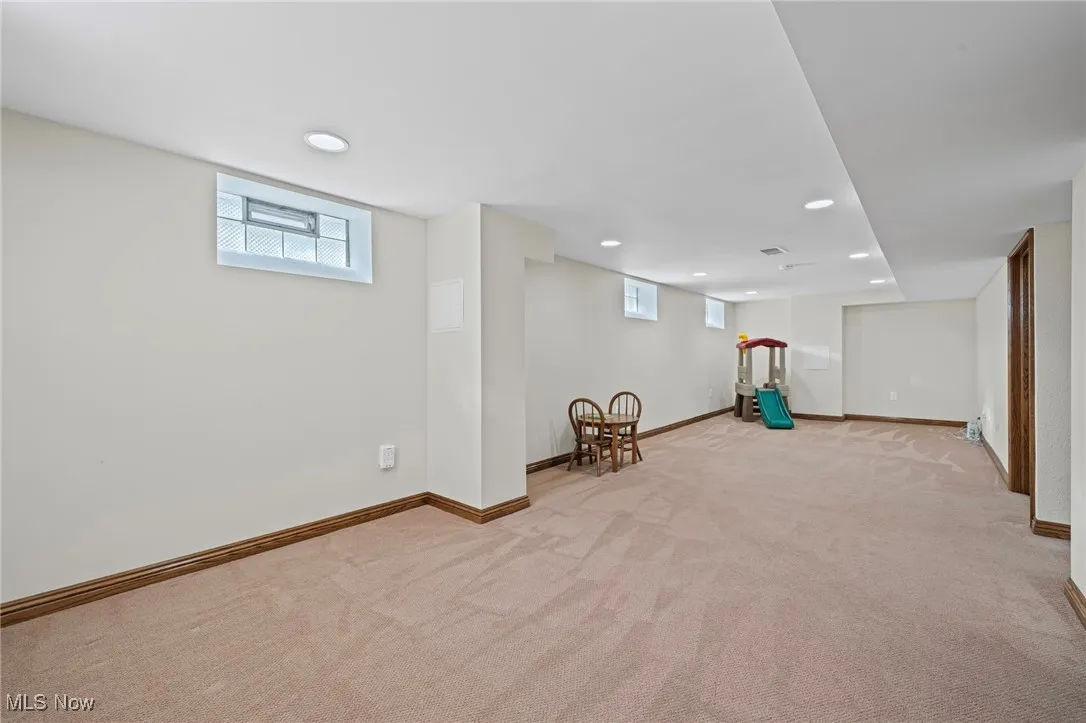 Below grade area featuring light carpet and recessed lighting