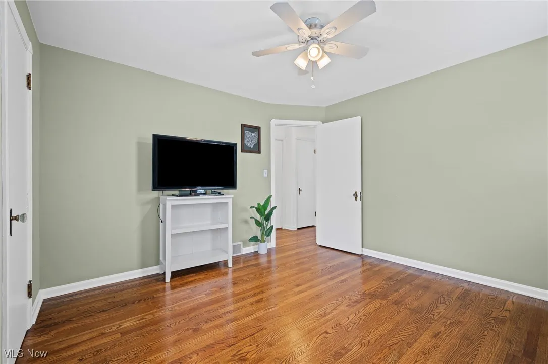 Bedroom with wood finished floors and ceiling fan