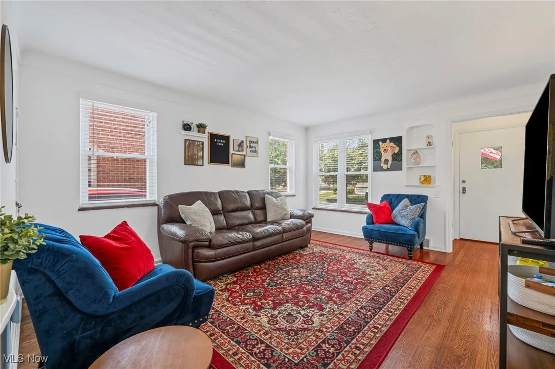 Living area with wood finished floors and baseboards