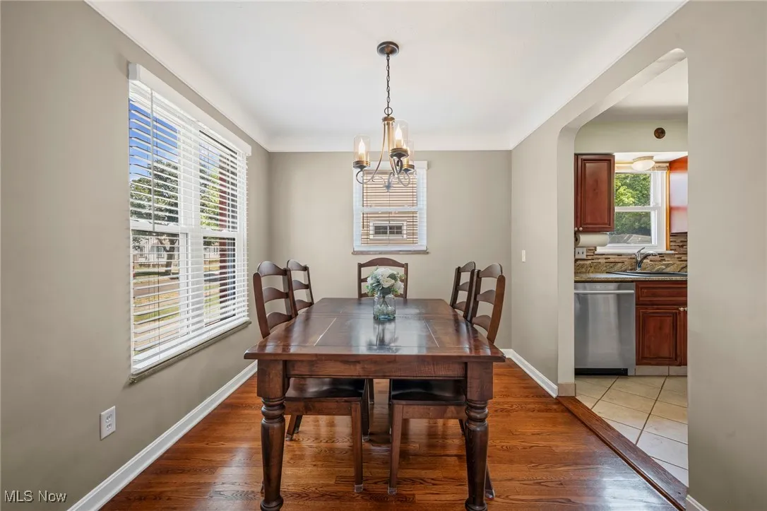 Dining room with light wood-style flooring and a chandelier