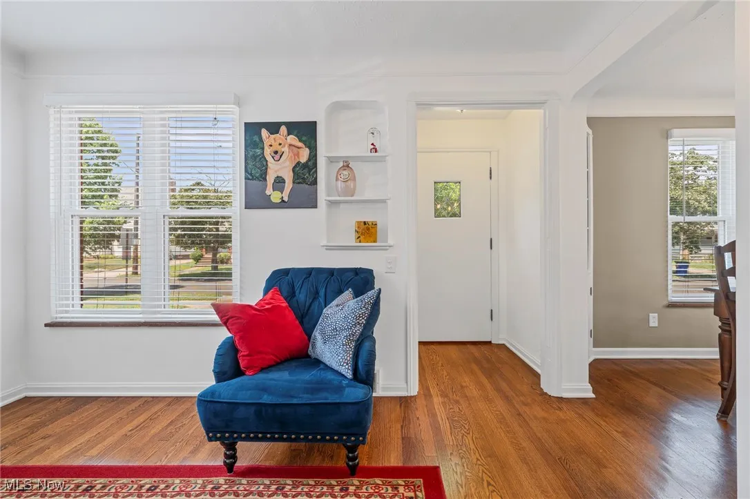 Sitting room with healthy amount of natural light and wood finished floors