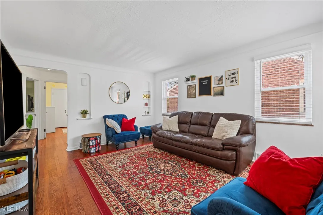 Living area featuring wood finished floors and a textured ceiling