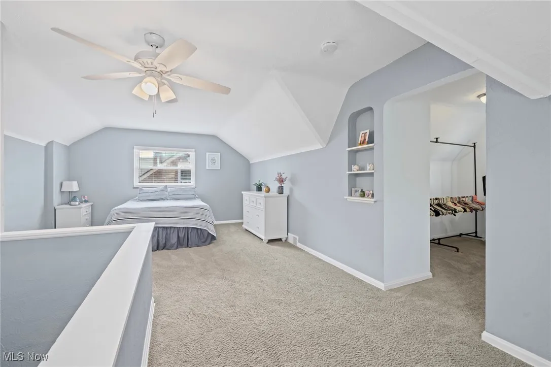 Bedroom with carpet floors, lofted ceiling, and ceiling fan