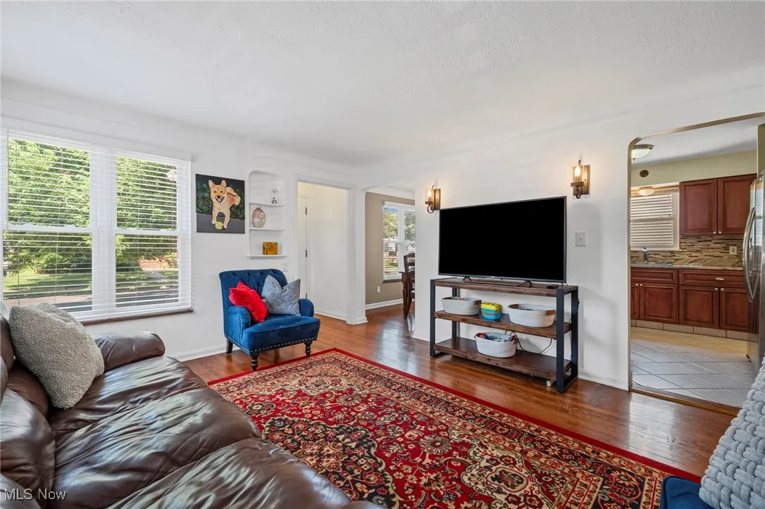 Living room featuring light wood-style floors and a textured ceiling