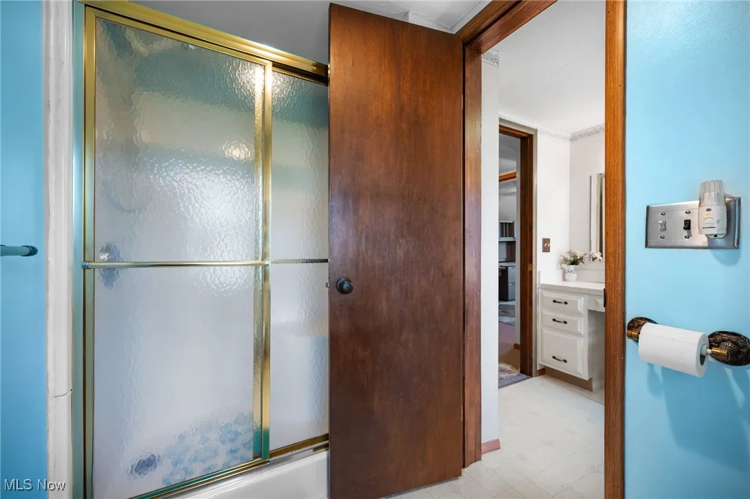 Full bathroom with tile patterned floors and vanity