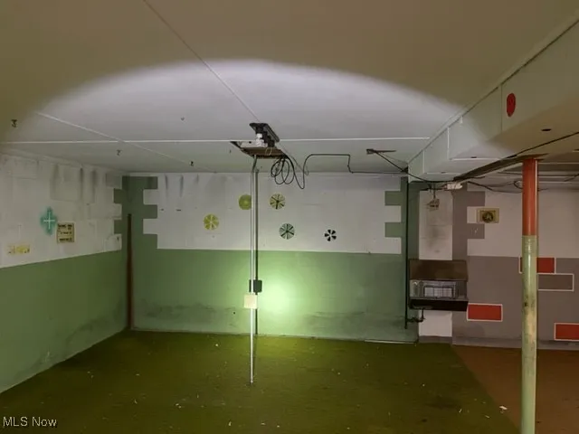 Basement featuring concrete block wall