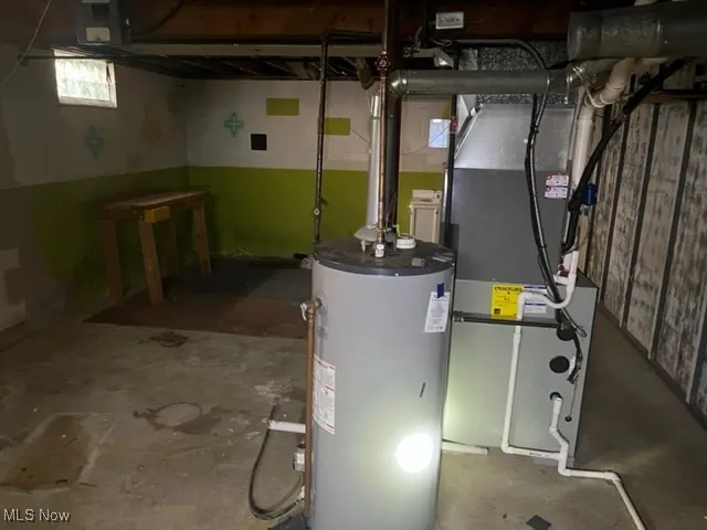 Utility room with gas water heater and heating unit