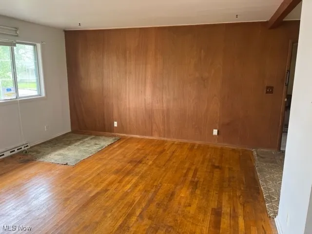 Empty room with wooden walls and wood finished floors
