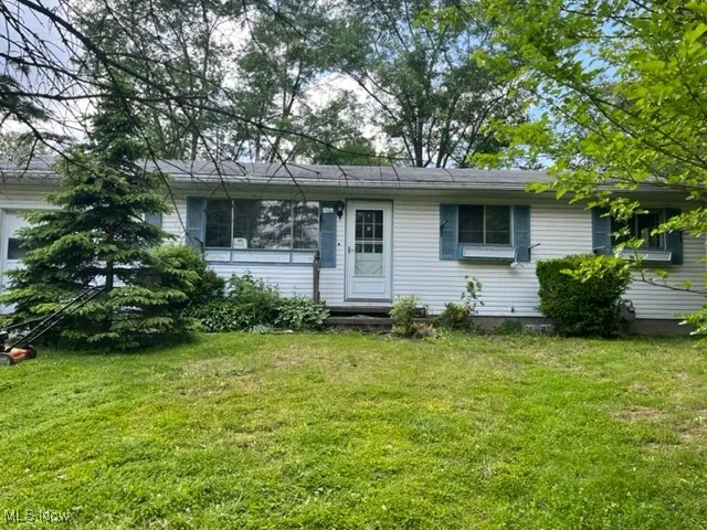 Ranch-style house with a front lawn
