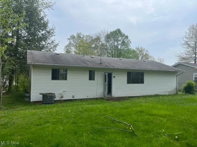 Back of property with a yard