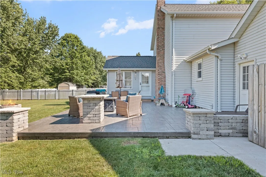 Fenced backyard with a patio and an outdoor hangout area
