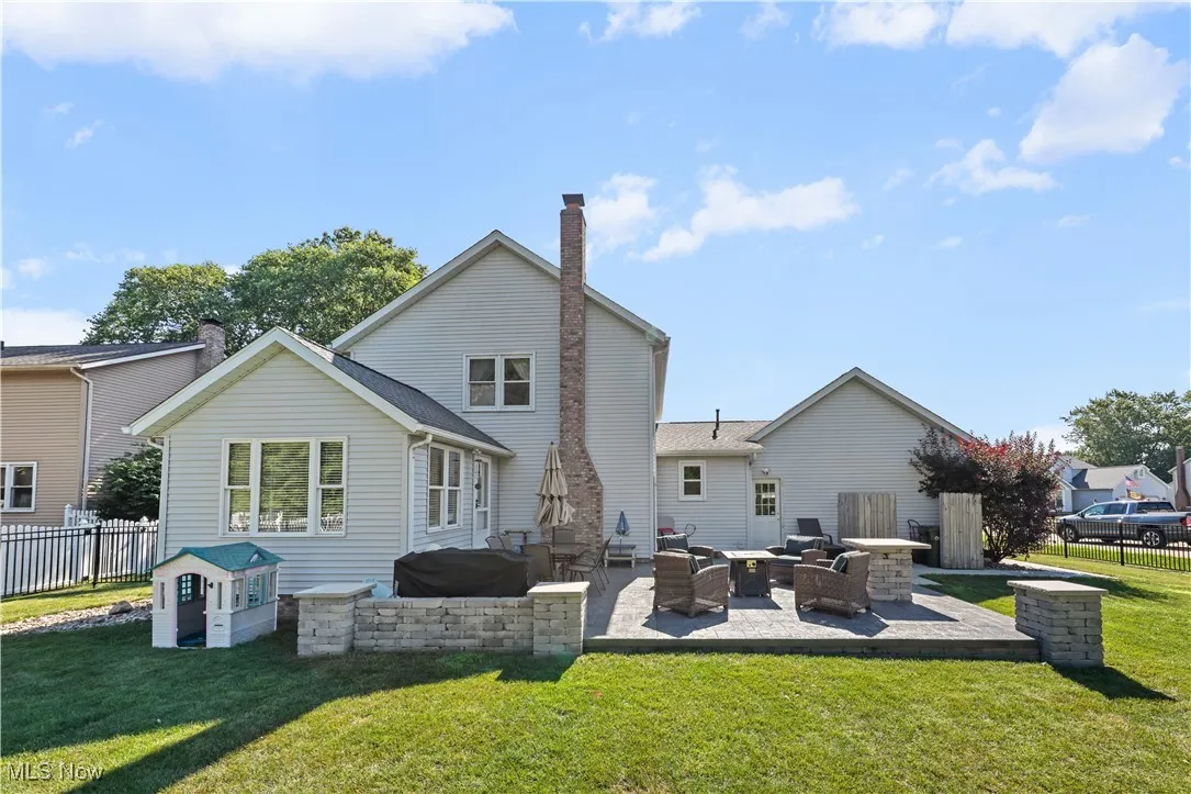 Back of property with a patio, a chimney, and outdoor lounge area