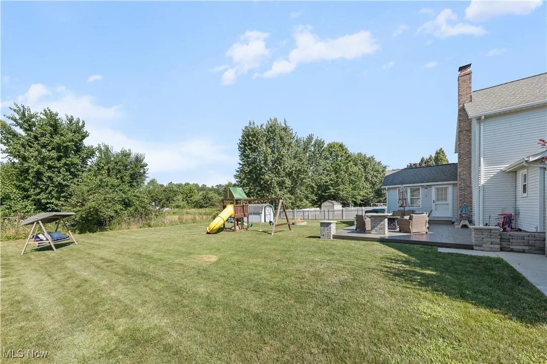 View of yard featuring an outdoor living space, a playground, and a patio area