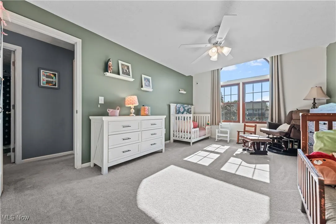 Carpeted bedroom with baseboards and ceiling fan