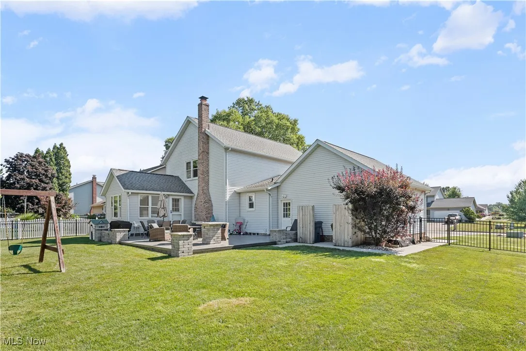 Back of property featuring outdoor lounge area, a fenced backyard, a chimney, and a patio