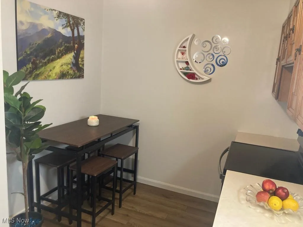 Dining space with dark wood finished floors and baseboards