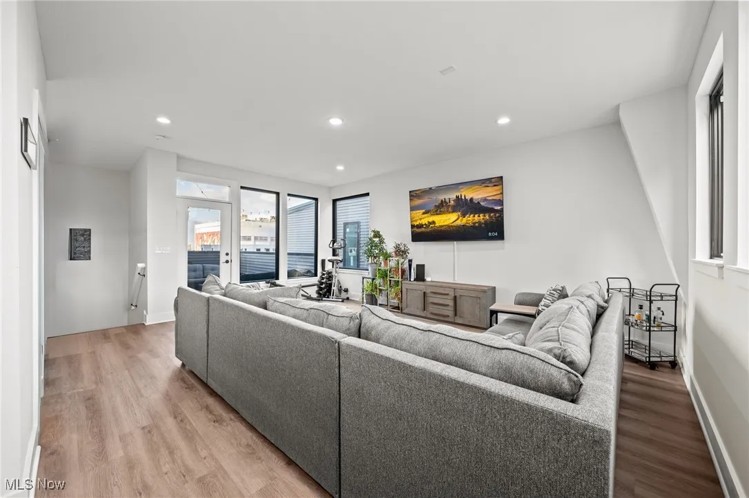 Living area with recessed lighting and light wood-style floors