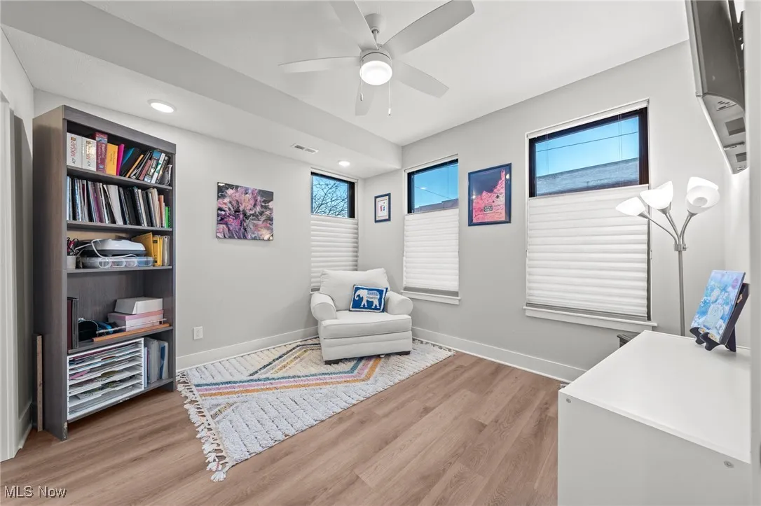 Sitting room featuring light wood finished floors, ceiling fan, and recessed lighting