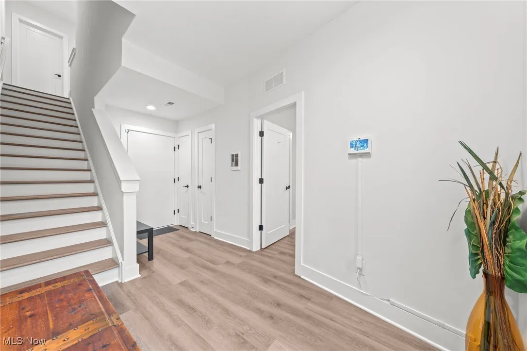 Foyer with light wood-type flooring and stairway