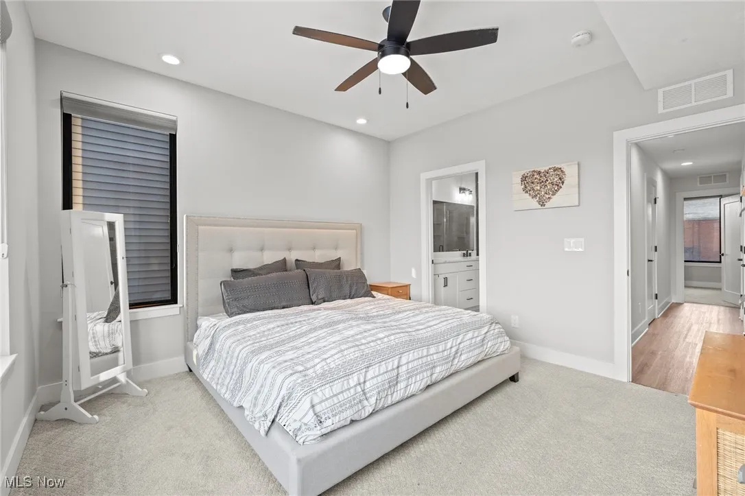 Carpeted bedroom with recessed lighting, a ceiling fan, and ensuite bathroom