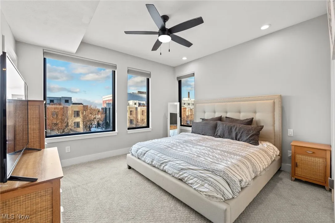 Carpeted bedroom with recessed lighting and ceiling fan