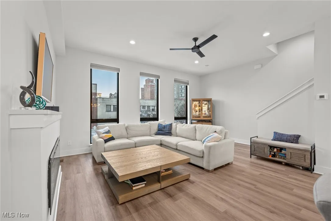 Living room with recessed lighting, ceiling fan, and light wood-type flooring