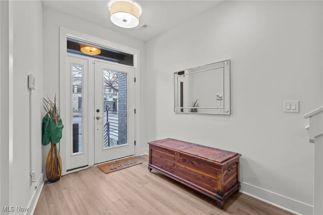 Foyer with wood finished floors and baseboards