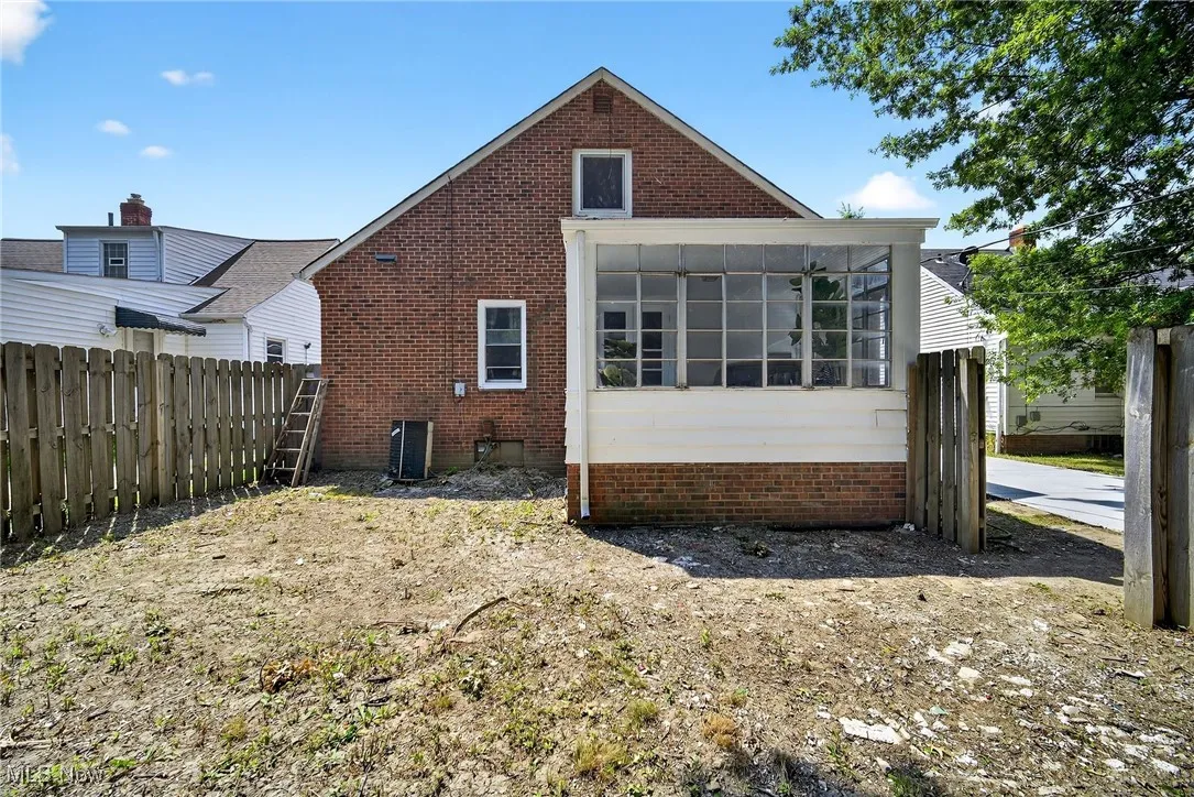 Back of property featuring brick siding
