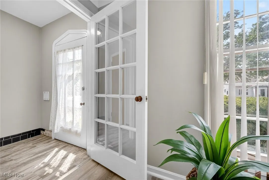 Doorway to outside featuring wood finished floors and baseboards