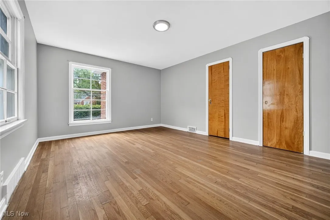 Empty room featuring wood finished floors and baseboards