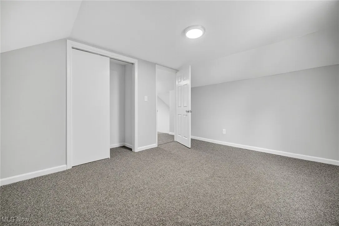 Additional living space with carpet and baseboards