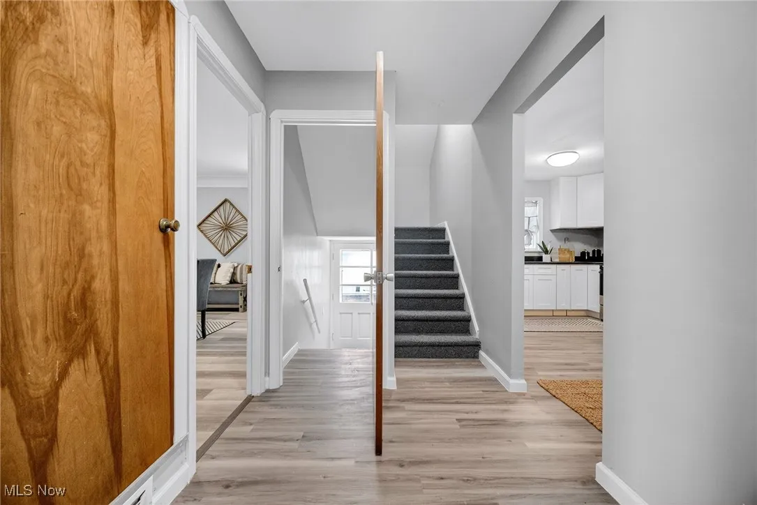 Staircase with wood finished floors and baseboards