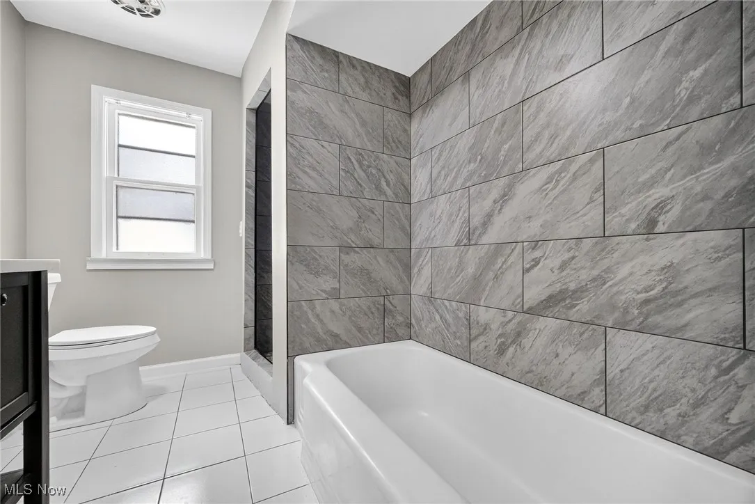 Bathroom with tile patterned floors and vanity