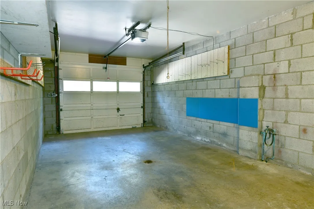 Garage with concrete block wall and a garage door opener