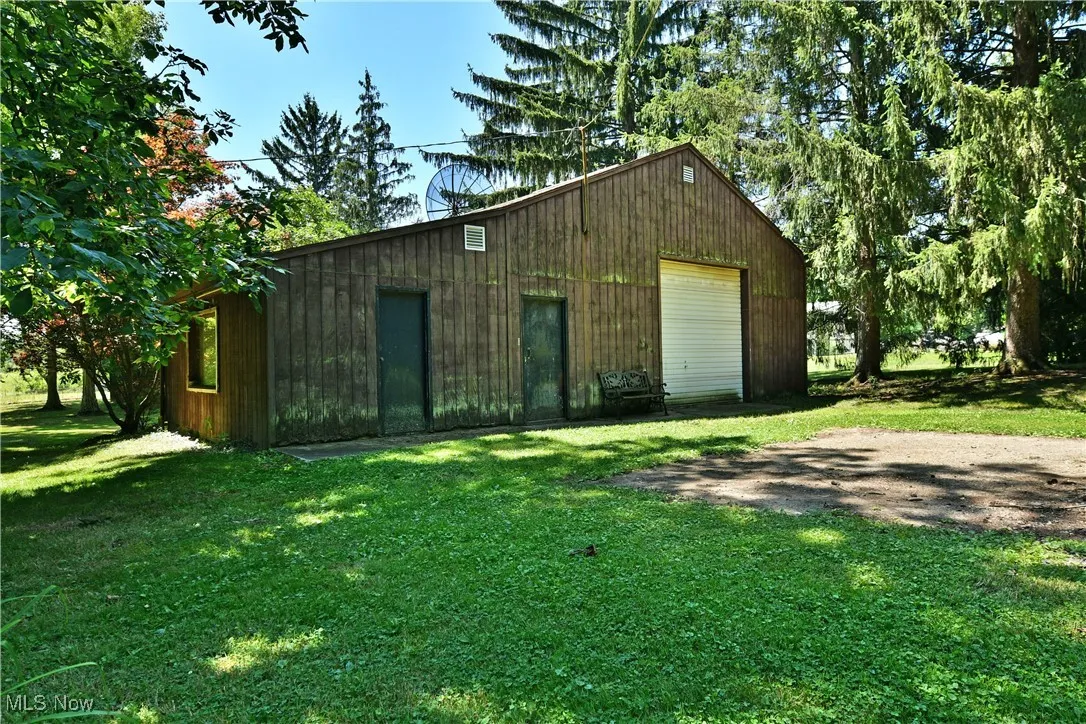 View of outdoor structure with driveway