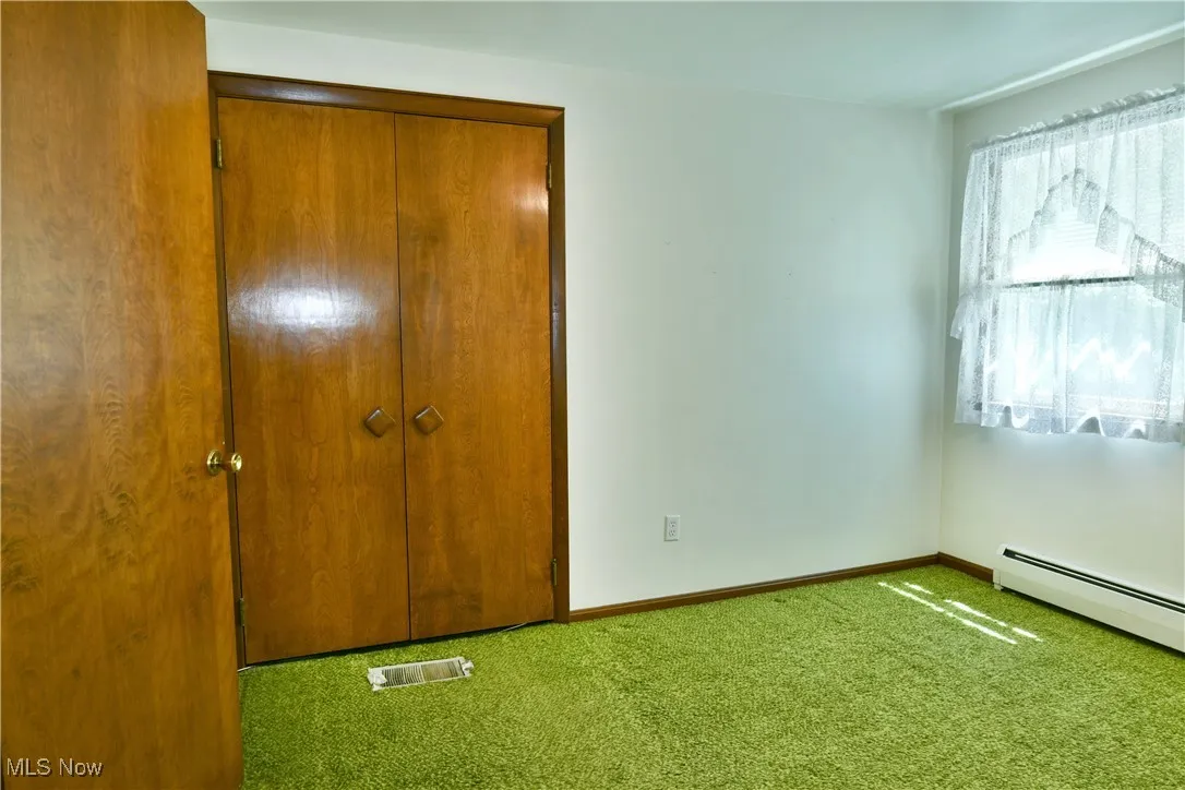 Unfurnished bedroom with carpet and a closet