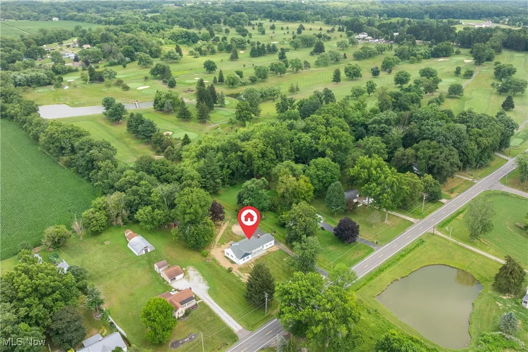 Bird's eye view of a tree filled landscape and a nearby body of water