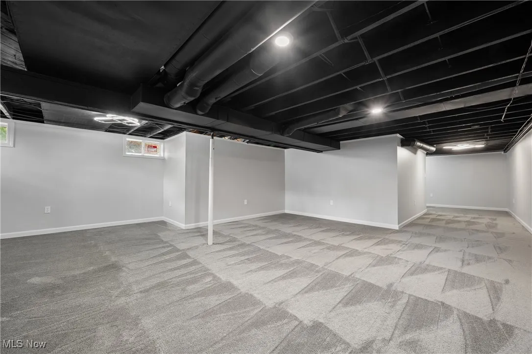 Basement featuring carpet flooring and plenty of natural light