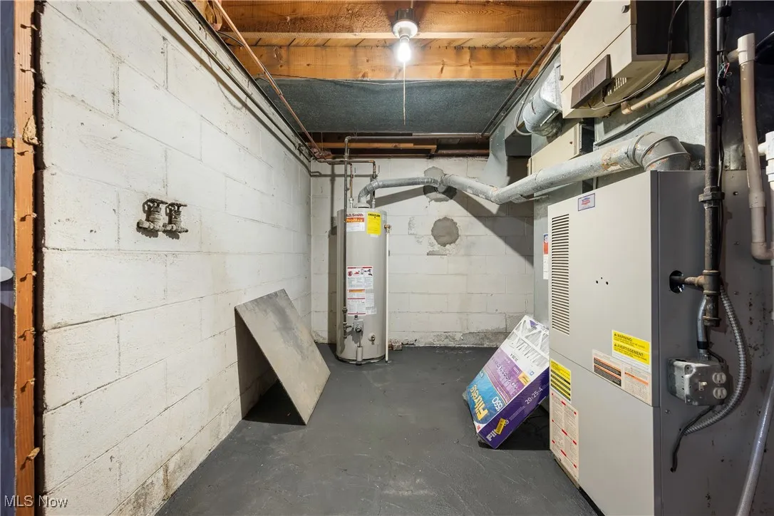 Unfinished below grade area with heating unit and water heater