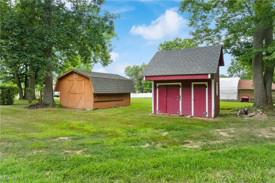 View of grassy yard featuring a storage shed