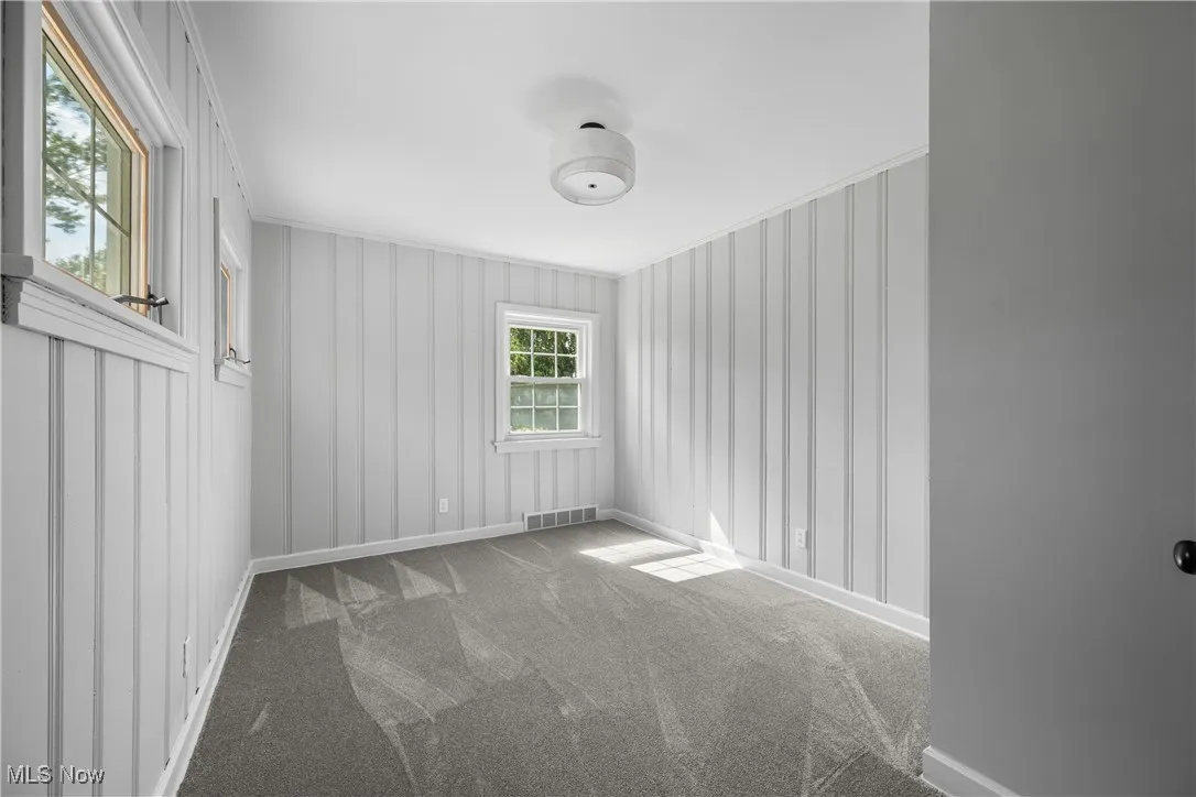 Unfurnished room with carpet floors and baseboards