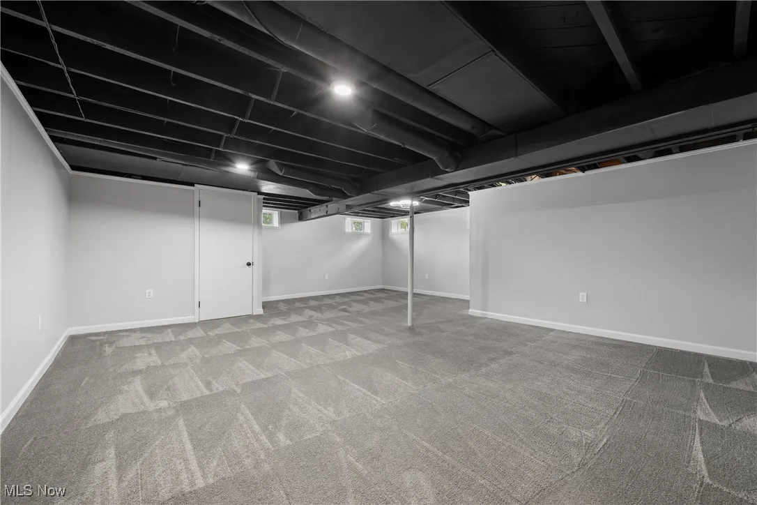 Basement with carpet flooring and baseboards