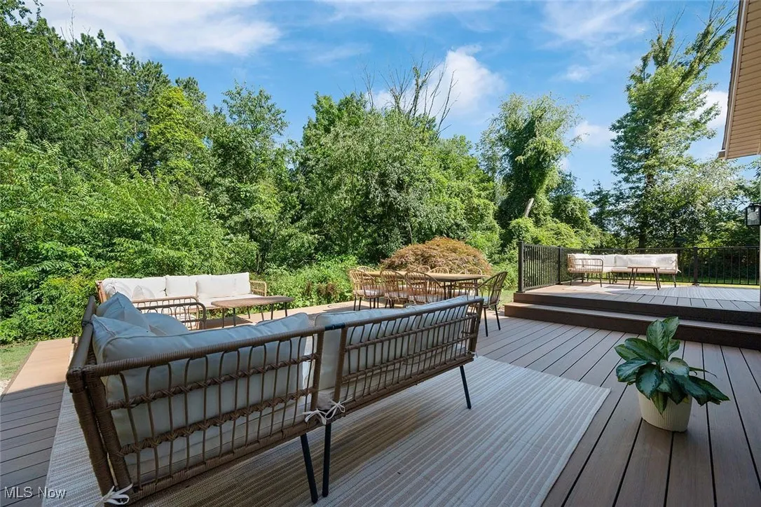 Wooden deck featuring an outdoor hangout area and outdoor dining space