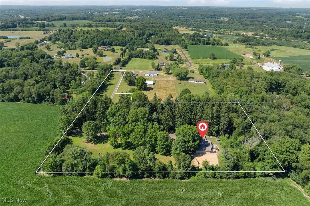 View of rural area with property boundaries highlighted and a forest