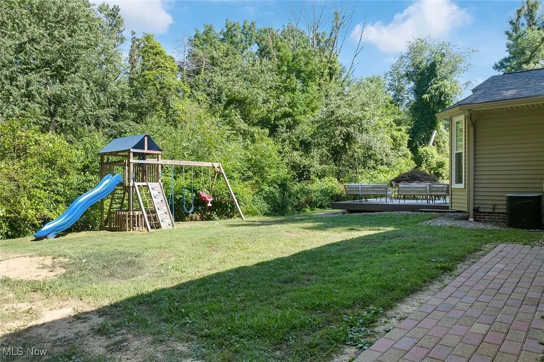View of grassy yard with a playground
