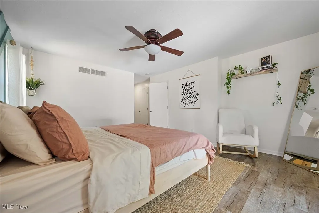 Bedroom featuring wood finished floors and a ceiling fan