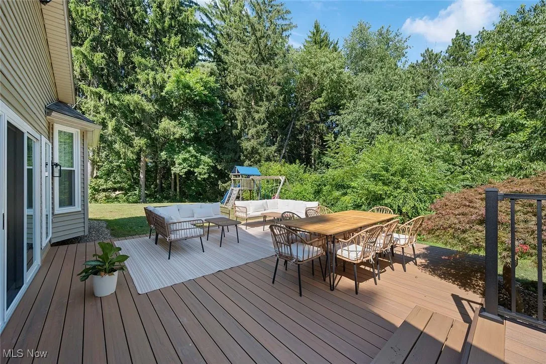 Wooden terrace featuring an outdoor hangout area and outdoor dining space