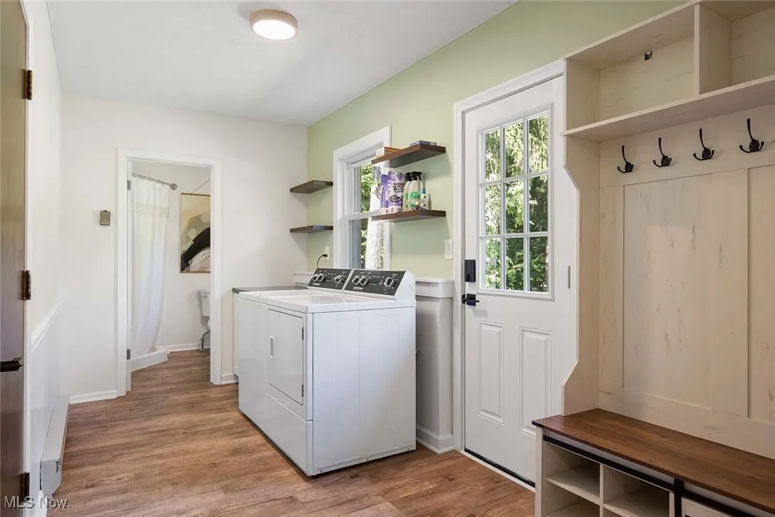 Laundry area featuring separate washer and dryer and light wood-type flooring
