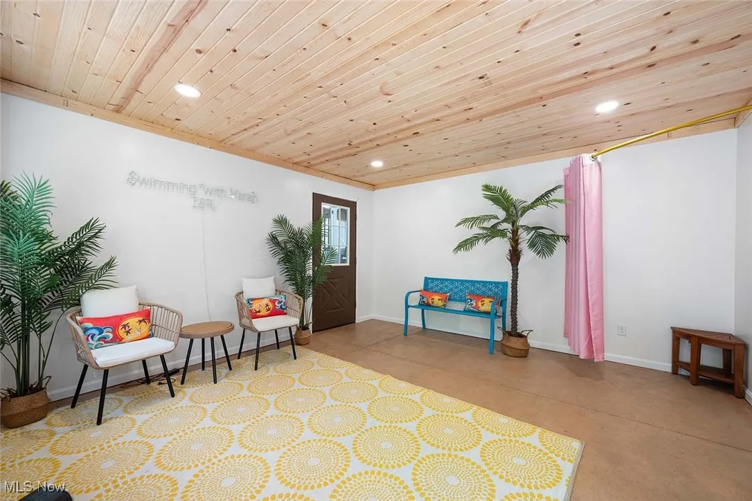 Pool area with wooden ceiling, recessed lighting, and concrete floors