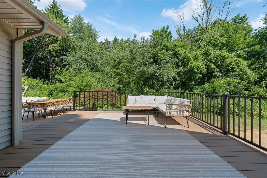 Wooden terrace with an outdoor hangout area and outdoor dining area
